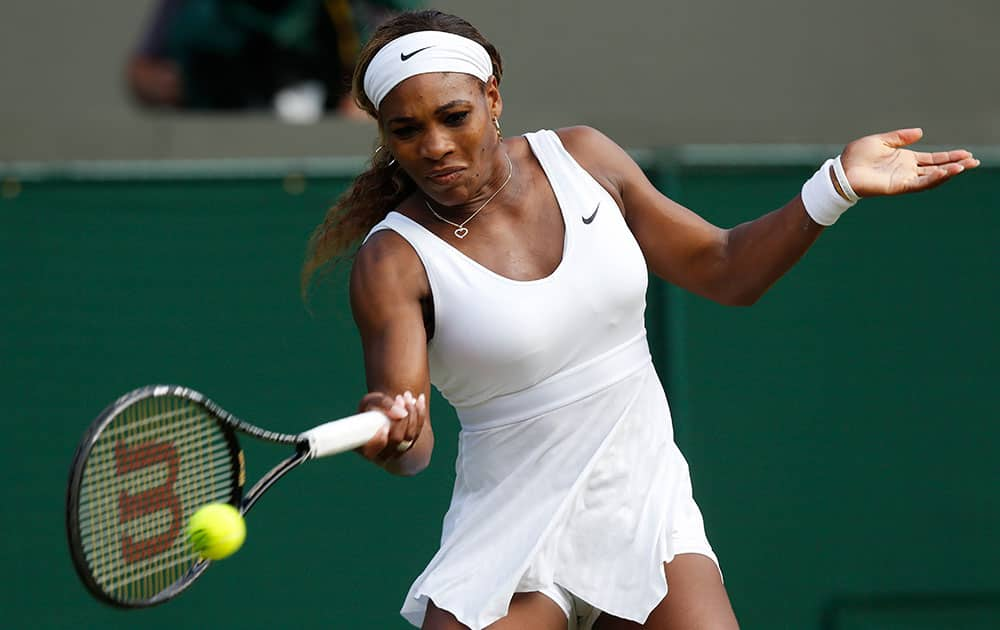 Serena Williams of U.S. plays a return to Alize Cornet of France during their women's singles match at the All England Lawn Tennis Championships in Wimbledon, London.