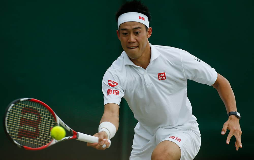 Kei Nishikori of Japan plays a return to Simone Bolelli of Italy during their men's singles match at the All England Lawn Tennis Championships in Wimbledon, London.