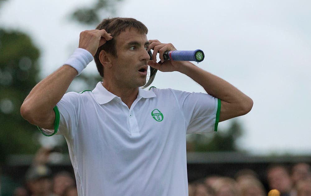 Tommy Robredo of Spain reacts to missing the chance for a match point against Jerzy Janowicz of Poland during their men's singles match at the All England Lawn Tennis Championships in Wimbledon, London.