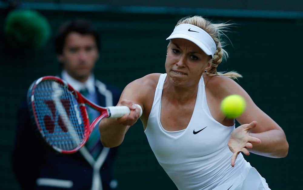 Sabine Lisicki of Germany returns to Ana Ivanovic of Serbia during their women's singles match at the All England Lawn Tennis Championships in Wimbledon, London.