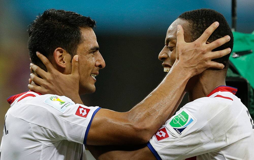 Costa Rica players celebrate after winning a penalty shootout at the end of the World Cup round of 16 soccer match between Costa Rica and Greece at the Arena Pernambuco in Recife, Brazil.