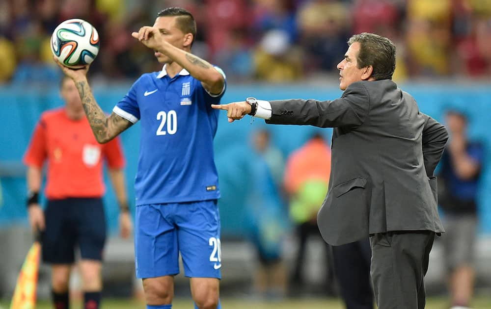 Costa Rica's head coach Jorge Luis Pinto gives instructions before Greece's Jose Holebas throws the ball into play during the World Cup round of 16 soccer match between Costa Rica and Greece at the Arena Pernambuco in Recife, Brazil.