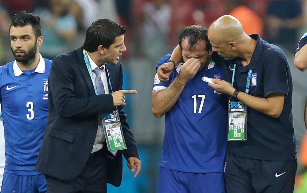 Greece's Fanis Gekas, center, is consoled by his teammates after a penalty shootout at the end of the World Cup round of 16 soccer match between Costa Rica and Greece at the Arena Pernambuco in Recife, Brazil.