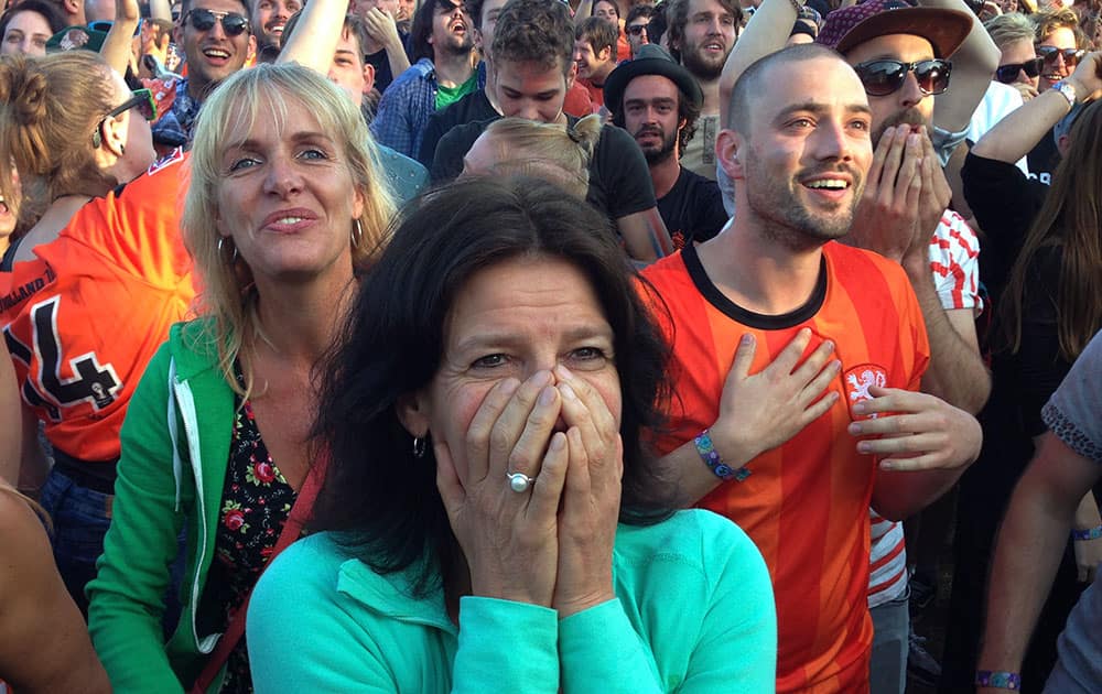 Festival goers celebrate as they watch the 2-1 win of the Dutch team in the World Cup round of 16 soccer match between the Netherlands and Mexico on the last day of the 'Down the Rabbit Hole' music festival in Beuningen, near Nijmegen.