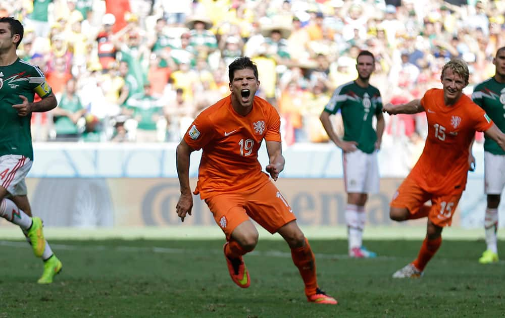 Netherlands' Klaas-Jan Huntelaar celebrates after scoring his side's second goal during the World Cup round of 16 soccer match between the Netherlands and Mexico at the Arena Castelao in Fortaleza, Brazil.