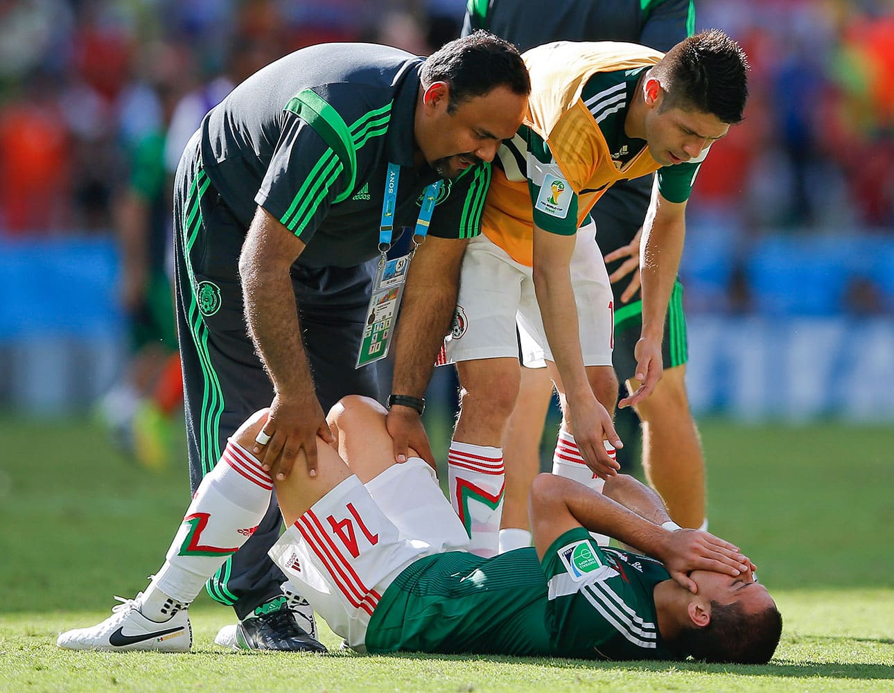 Teammates try to console Mexico's Javier Hernandez after the Netherlands defeated Mexico 2-1 to advance to the quarterfinals during the World Cup round of 16 soccer match between the Netherlands and Mexico at the Arena Castelao in Fortaleza, Brazil.