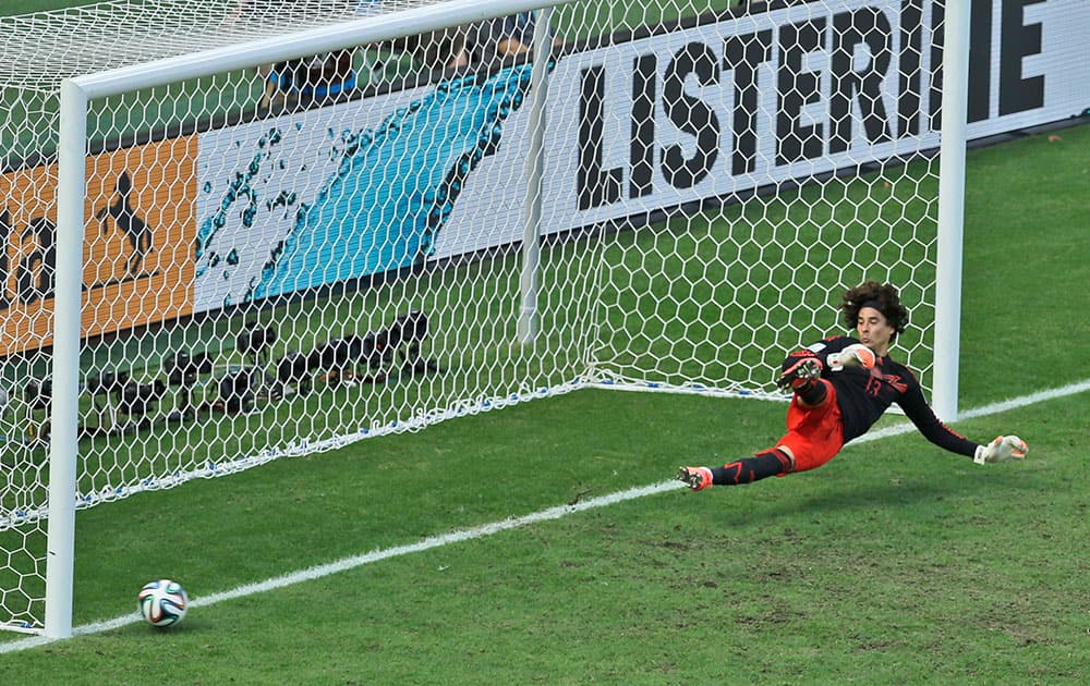 Mexico's goalkeeper Guillermo Ochoa fails to save a shot by Netherlands' Klaas-Jan Huntelaar from the penalty spot during the World Cup round of 16 soccer match between the Netherlands and Mexico at the Arena Castelao in Fortaleza, Brazil.