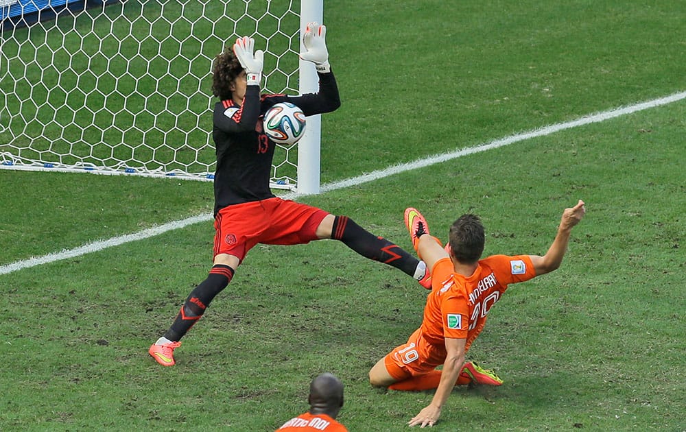 Mexico's goalkeeper Guillermo Ochoa makes a save after a shot by Netherlands' Klaas-Jan Huntelaar during the World Cup round of 16 soccer match between the Netherlands and Mexico at the Arena Castelao in Fortaleza, Brazil.