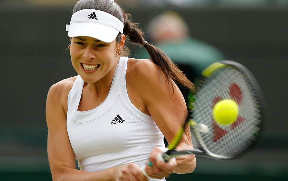 Ana Ivanovic of Serbia plays a return to Sabine Lisicki of Germany during their women's singles match at the All England Lawn Tennis Championships in Wimbledon.