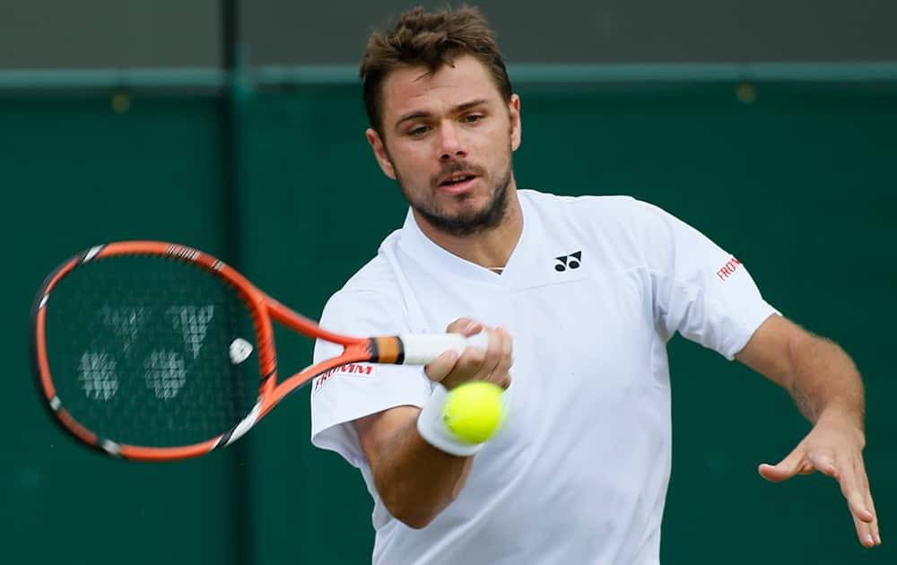 Stan Wawrinka of Switzerland plays a return to Denis Istomin of Uzbekistan during their match at the All England Lawn Tennis Championships in Wimbledon, London.