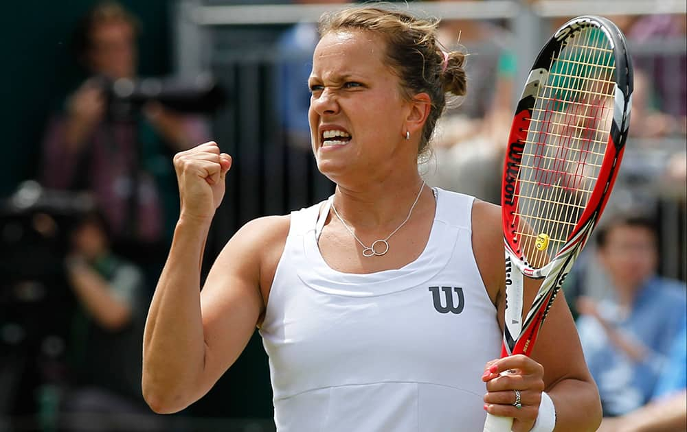 Barbora Zahlavova Strycova of the Czech Republic celebrates a point to Caroline Wozniacki of Denmark during their match at the All England Lawn Tennis Championships in Wimbledon.