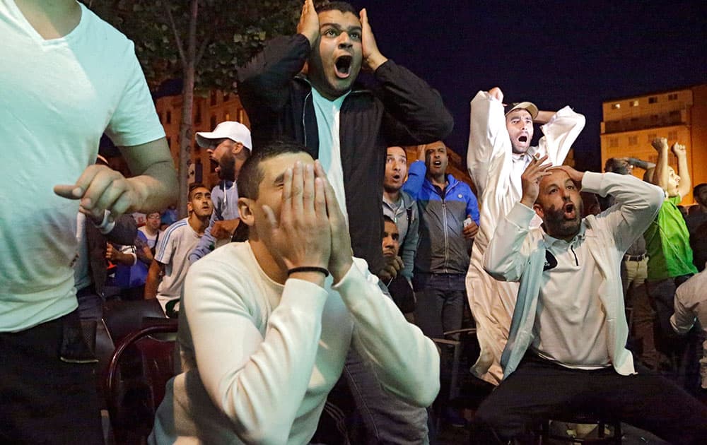 Algerian soccer fans react as they watch the Brazil World Cup round of 16 soccer match between Germany and Algeria at a bar in Marseille.