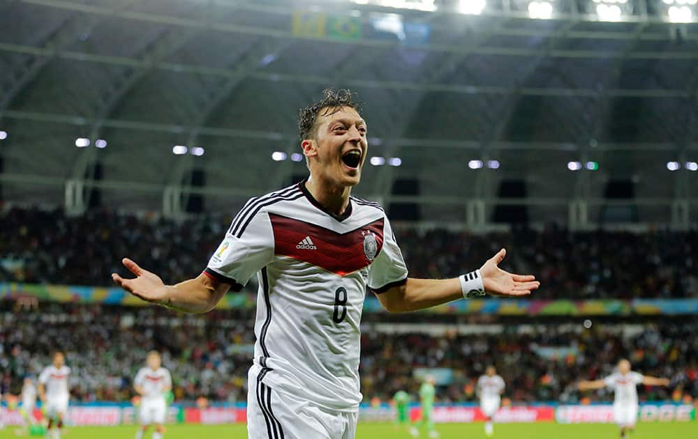 Germany's Mesut Ozil celebrates after scoring his side's second goal in extra time during the World Cup round of 16 soccer match between Germany and Algeria at the Estadio Beira-Rio in Porto Alegre, Brazil.