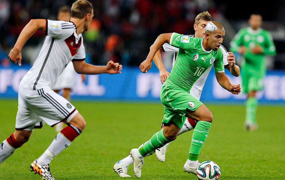 Algeria's Sofiane Feghouli runs with the ball during the World Cup round of 16 soccer match between Germany and Algeria at the Estadio Beira-Rio in Porto Alegre, Brazil.