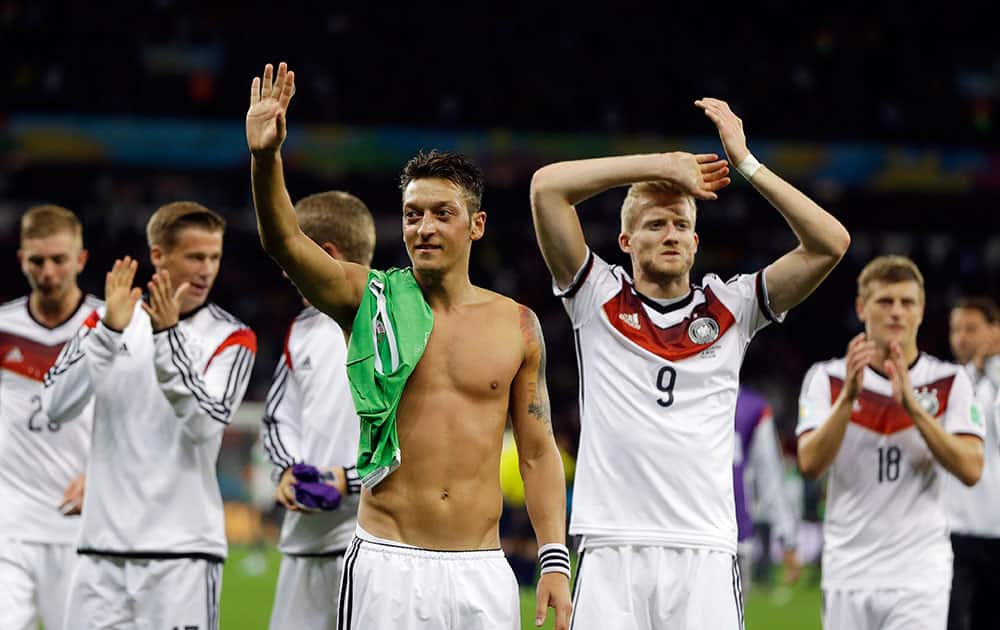 Germany's Mesut Ozil, left, and teammate Andre Schuerrle (9) celebrate after Germany defeated Algeria 2-1 in extra time during the World Cup round of 16 soccer match between Germany and Algeria at the Estadio Beira-Rio in Porto Alegre, Brazil.