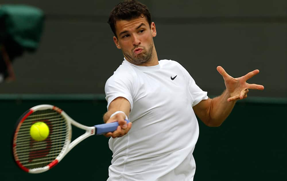 Grigor Dimitrov of Bulgaria plays a return to Leonardo Mayer of Argentina during their men’s singles match at the All England Lawn Tennis Championships in Wimbledon.