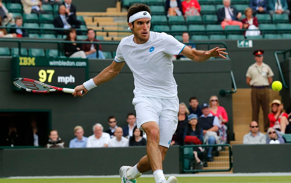 Leonardo Mayer of Argentina plays a return to Grigor Dimitrov of Bulgaria during their men’s singles match at the All England Lawn Tennis Championships in Wimbledon, London.