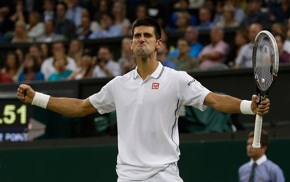 Novak Djokovic of Serbia celebrates defeating Jo-Wilfried Tsonga of France in their men's singles match at the All England Lawn Tennis Championships in Wimbledon, London.