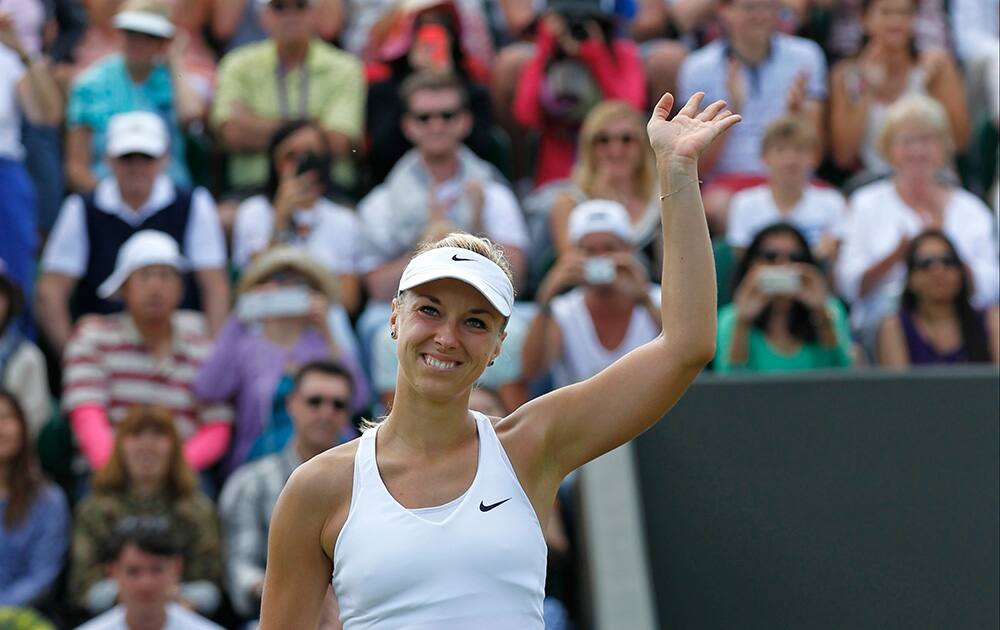 Sabine Lisicki of Germany celebrates defeating Yaroslava Shvedova of Kazakhstan during their women's singles match at the All England Lawn Tennis Championships in Wimbledon, London.