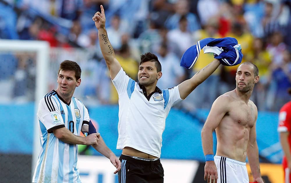 Argentina's Sergio Aguero, center, celebrates next to teammates Lionel Messi, left, and Argentina's Pablo Zabaleta, right, at the end of the World Cup round of 16 soccer match between Argentina and Switzerland at the Itaquerao Stadium in Sao Paulo, Brazil.