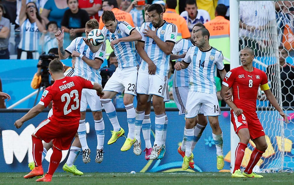 Argentina's defensive wall blocks a free kick by Switzerland's Xherdan Shaqiri, left, on the last minutes of their World Cup round of 16 soccer match at the Itaquerao Stadium in Sao Paulo, Brazil.