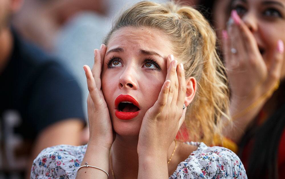 A Swiss supporter reacts as she watches Argentina score a goal during the FIFA World Cup round of 16 soccer match between Argentina and Switzerland taking place in Brazil.