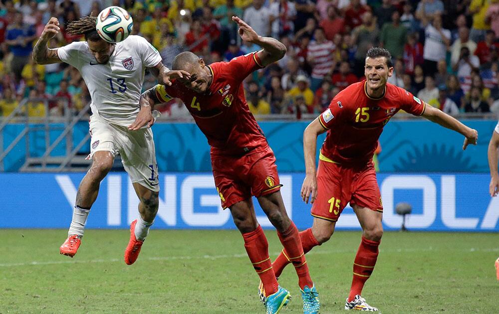 United States' Jermaine Jones, left, is challenged by Belgium's Vincent Kompany during the World Cup round of 16 soccer match between Belgium and the USA at the Arena Fonte Nova in Salvador, Brazil.