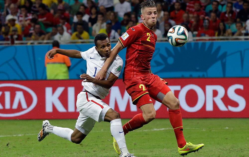 United States' Julian Green, left, scores his side's first goal during the World Cup round of 16 soccer match between Belgium and the USA at the Arena Fonte Nova in Salvador, Brazil.