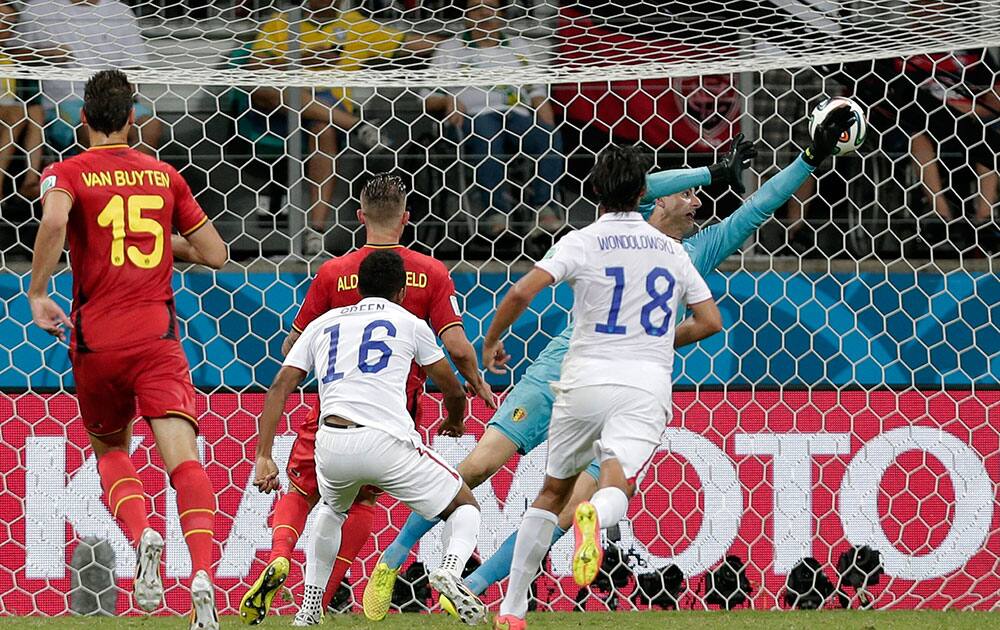 Belgium's goalkeeper Thibaut Courtois can not stop a shot by United States' Julian Green (16) as Green scores his side's first goal in extra time during the World Cup round of 16 soccer match between Belgium and the USA at the Arena Fonte Nova in Salvador, Brazil.