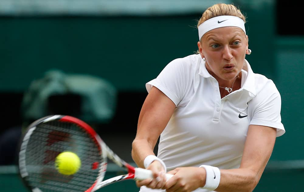 Petra Kvitova of Czech Republic plays a return to Barbora Zahlavova Strycova of Czech Republic during their women's singles quarterfinal match at the All England Lawn Tennis Championships in Wimbledon.