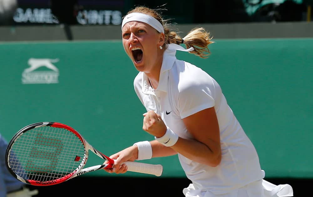 Petra Kvitova of Czech Republic celebrates winning the first set as she plays against Lucie Safarova of Czech Republic during their women’s singles semifinal match at the All England Lawn Tennis Championships in Wimbledon.