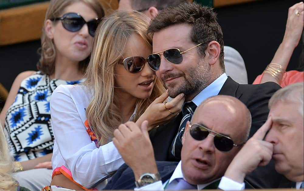 Bradley Cooper and Suki Waterhouse sit in the Royal Box on centre court to watch the men's singles semifinal match between Novak Djokovic of Serbia and Grigor Dimitrov of Bulgaria at the All England Lawn Tennis Championships in Wimbledon, London.