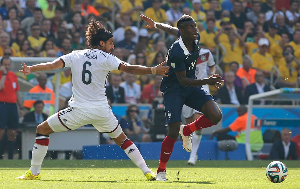 France's Paul Pogba, right, gets away from Germany's Sami Khedira during the World Cup quarterfinal soccer match between Germany and France at the Maracana Stadium in Rio de Janeiro, Brazil.