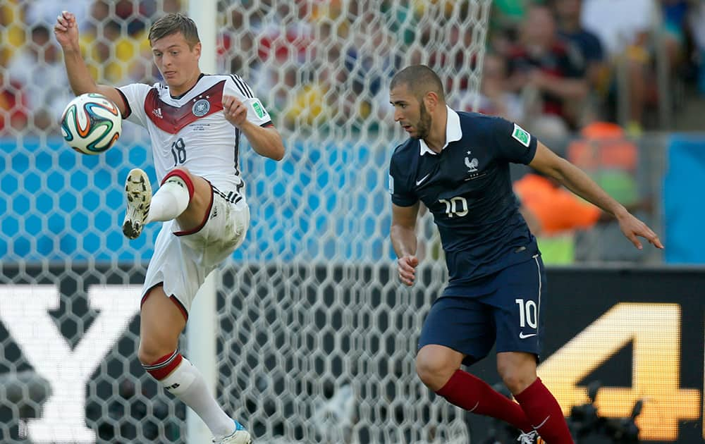 Germany's Toni Kroos controls the ball as France's Karim Benzema looks on during the World Cup quarterfinal soccer match between Germany and France at the Maracana Stadium in Rio de Janeiro, Brazil.