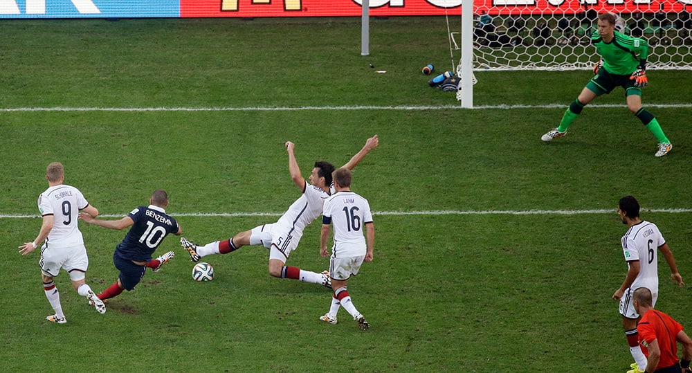 France's Karim Benzema, second left, fires a shot during the World Cup quarterfinal soccer match between Germany and France at the Maracana Stadium in Rio de Janeiro, Brazil.