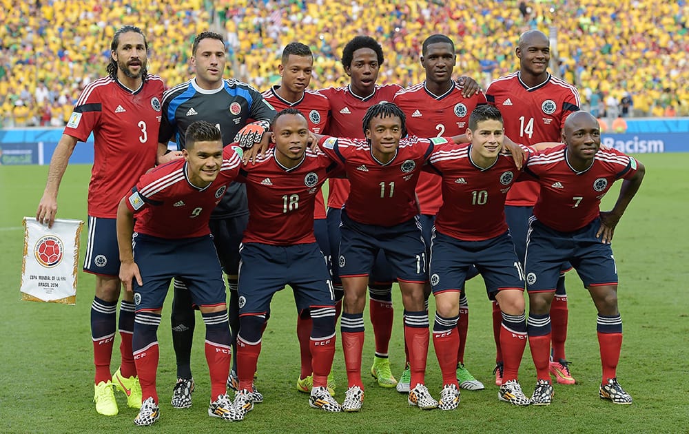 The Colombian team poses for a group photo before the World Cup quarterfinal soccer match between Brazil and Colombia at the Arena Castelao in Fortaleza, Brazil.