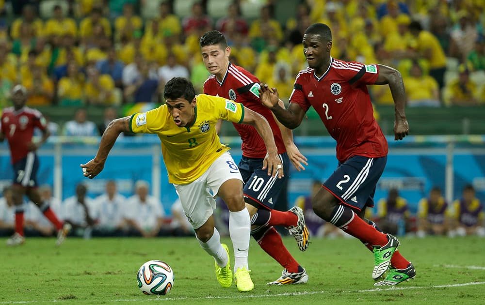 Brazil's Paulinho controls the ball past Colombia's James Rodriguez and Cristian Zapata during the World Cup quarterfinal soccer match between Brazil and Colombia at the Arena Castelao in Fortaleza, Brazil.