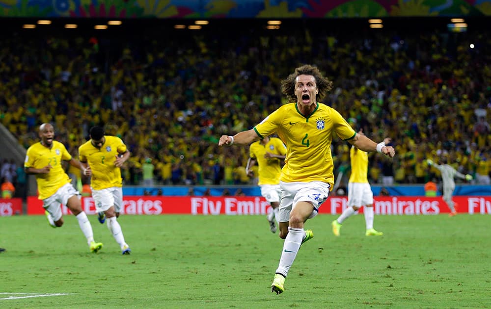 Brazil's David Luiz celebrates after scoring his side's second goal on a free kick during the World Cup quarterfinal soccer match between Brazil and Colombia at the Arena Castelao in Fortaleza, Brazil.