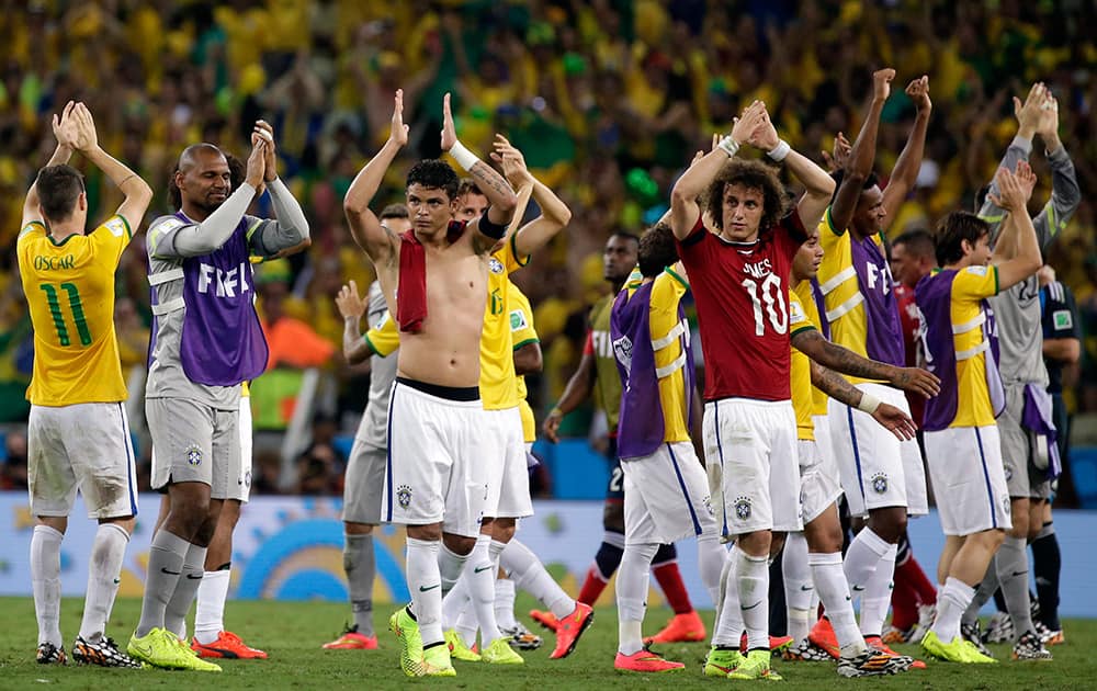 Brazil players celebrate at the end of the World Cup quarterfinal soccer match between Brazil and Colombia at the Arena Castelao in Fortaleza, Brazil.