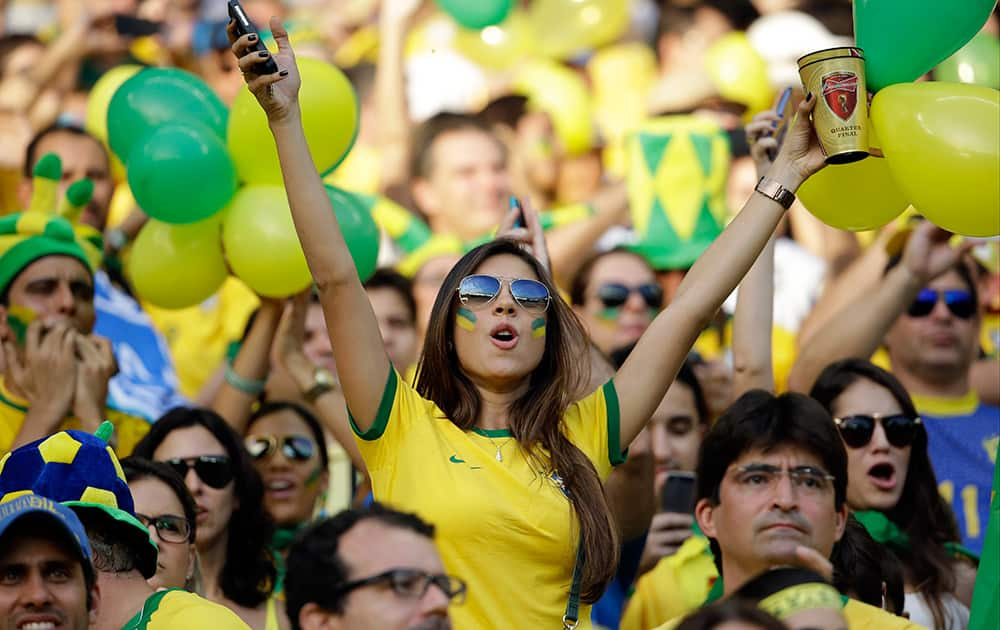 A brazil fan cheers before the World Cup quarterfinal soccer match between Brazil and Colombia at the Arena Castelao in Fortaleza.