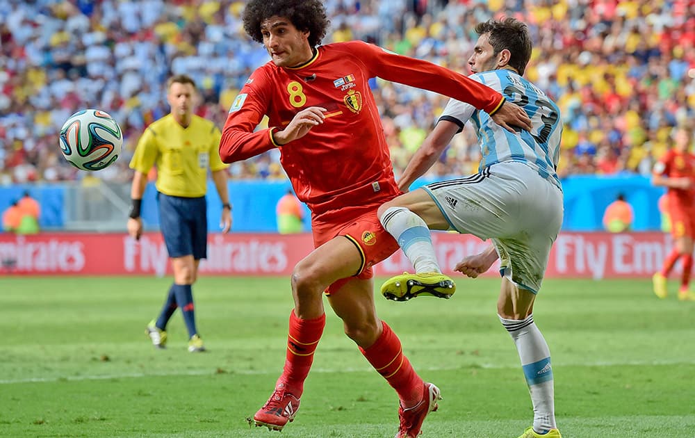 Belgium's Marouane Fellaini, left, battles for the ball with Argentina's Jose Maria Basanta during the World Cup quarterfinal soccer match between Argentina and Belgium at the Estadio Nacional in Brasilia, Brazil.