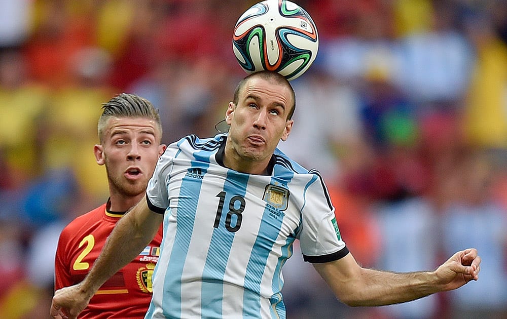 Argentina's Rodrigo Palacio wins a header during the World Cup quarterfinal soccer match between Argentina and Belgium at the Estadio Nacional in Brasilia, Brazil.