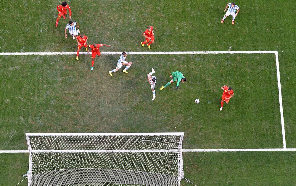 Belgium's goalkeeper Thibaut Courtois makes a save as players stand around him during the World Cup quarterfinal soccer match between Argentina and Belgium at the Estadio Nacional in Brasilia, Brazil.