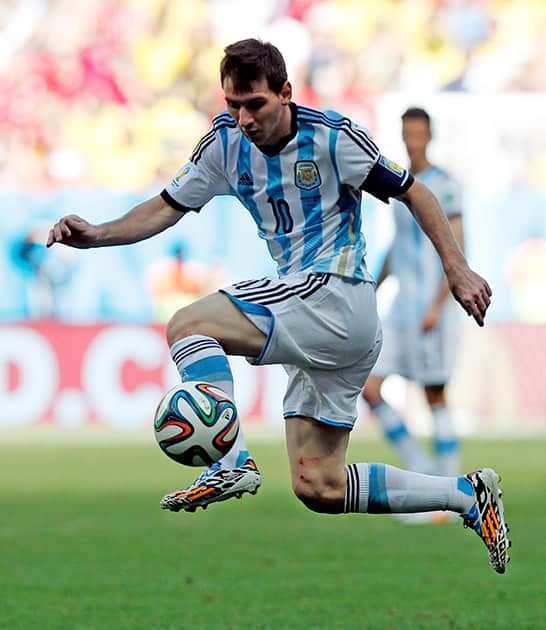 Argentina's Lionel Messi leaps the catch a pass during the World Cup quarterfinal soccer match between Argentina and Belgium at the Estadio Nacional in Brasilia, Brazil.