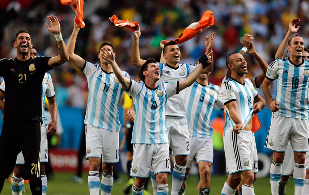  Argentina's Lionel Messi and teammates celebrate at the end of the World Cup quarterfinal soccer match between Argentina and Belgium at the Estadio Nacional in Brasilia, Brazil.