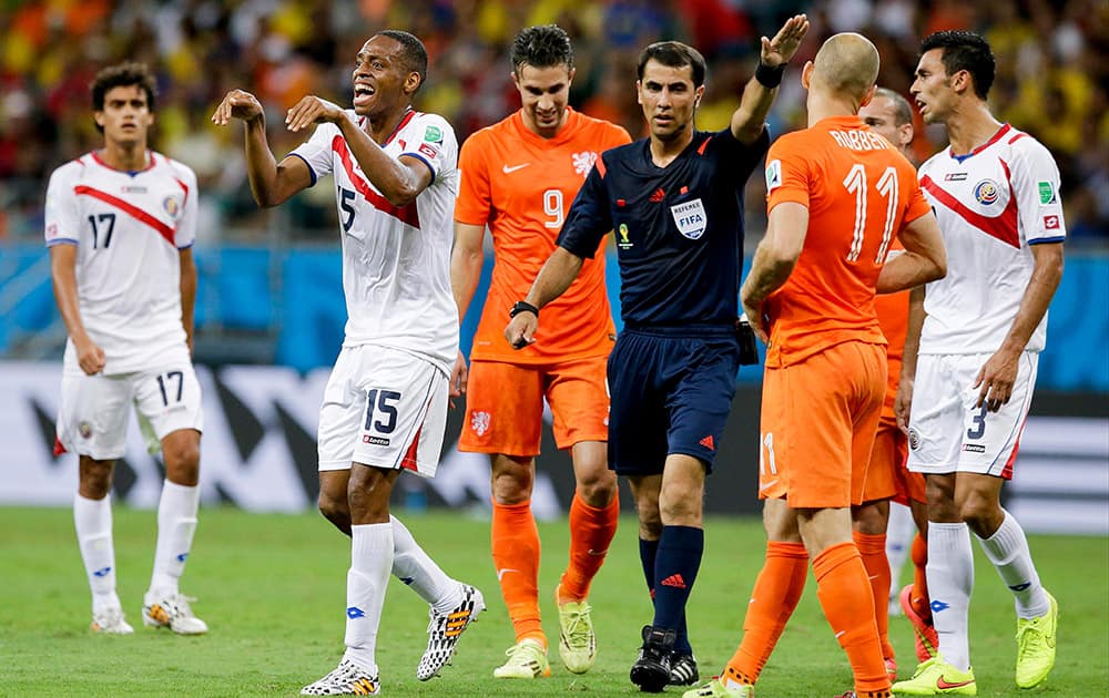 Costa Rica's Junior Diaz, second from left, gestures suggesting that Netherlands' Arjen Robben took a dive during the World Cup quarterfinal soccer match between the Netherlands and Costa Rica at the Arena Fonte Nova in Salvador, Brazil.