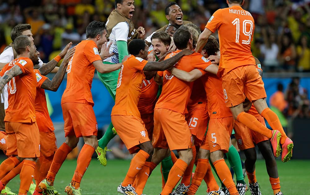 Netherlands' players celebrate after winning on penalty kicks the World Cup quarterfinal soccer match between the Netherlands and Costa Rica at the Arena Fonte Nova in Salvador, Brazil.