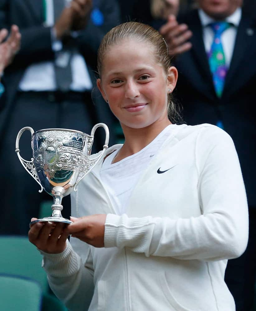 Jelena Ostapenko of Latvia holds the trophy after defeating Kristina Schmiedlova of Slovakia in the girls’ singles final at the All England Lawn Tennis Championships in Wimbledon.