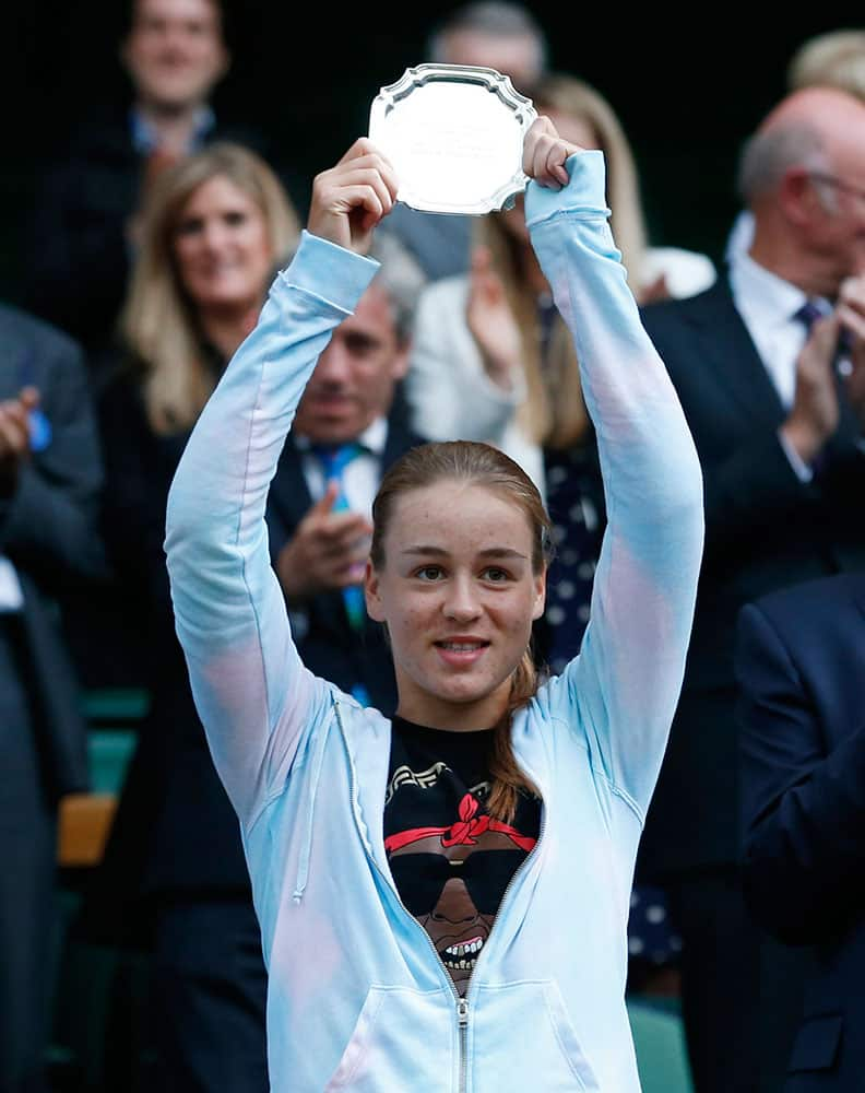 Kristina Schmiedlova of Slovakia holds the runners up trophy after being defeated by Jelena Ostapenko of Latvia in the girls’ singles final at the All England Lawn Tennis Championships in Wimbledon.