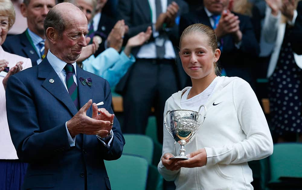 The Duke of Kent presents Jelena Ostapenko of Latvia with the trophy after she defeated Kristina Schmiedlova of Slovakia in the girls’ singles final at the All England Lawn Tennis Championships in Wimbledon.